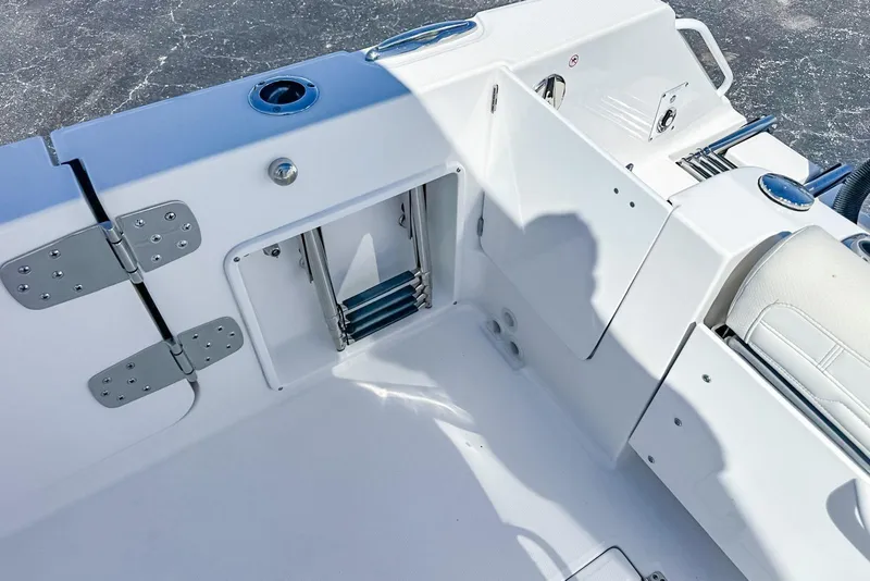 Slide: The Image of 2025 Edgewater 262CX Crossover boat interior with ladder and seating area. - 38