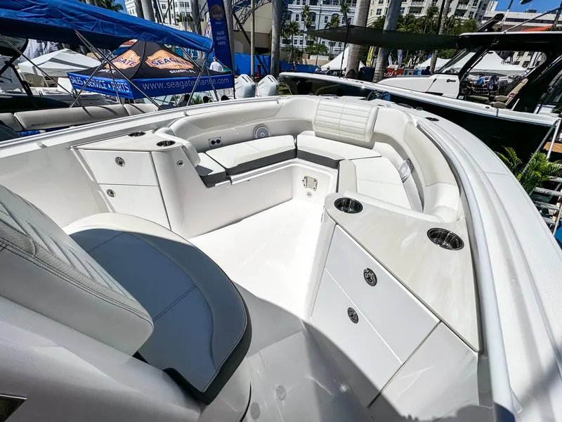 Slide: The Image of 2025 Edgewater 262CC boat interior with white seating and storage compartments. - 11