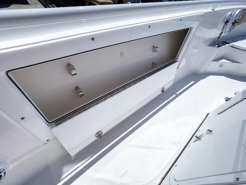 Slide: The Image of 2025 Edgewater 325CC boat storage compartment, open and spacious, showcasing sleek design. - 21