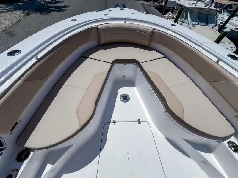 Slide: The Image of 2025 Edgewater 325CC boat with spacious, cushioned seating area in the bow. - 28