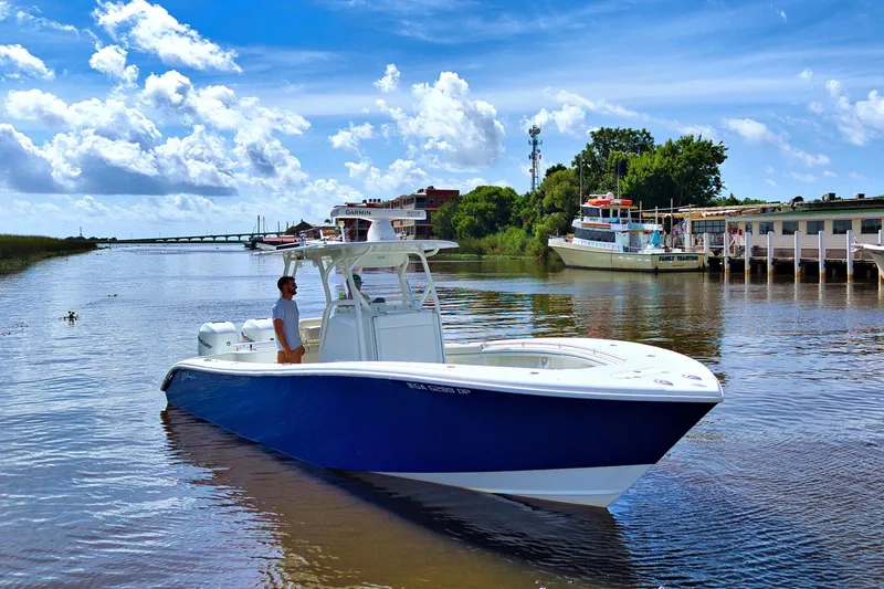 Slide: The Image of 2017 Yellowfin 32 Offshore boat on calm water under a bright blue sky. - 2