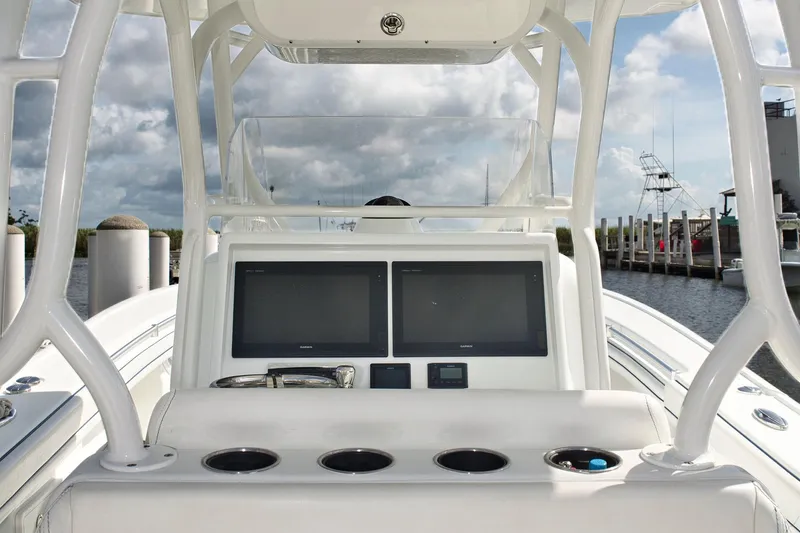 Slide: The Image of 2017 Yellowfin 32 Offshore boat console with dual screens and cup holders. - 8
