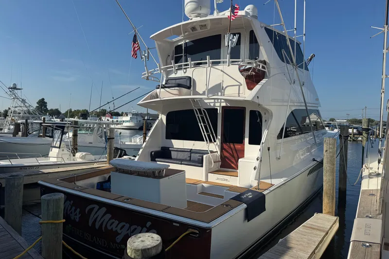 Slide: The Image of 2002 Viking 61 Enclosed Bridge yacht docked at marina, rear view. - 10