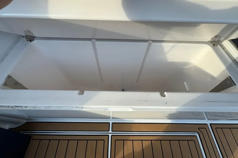 Slide: The Image of Open storage compartment on 2002 Viking 61 Enclosed Bridge yacht with wooden deck. - 16