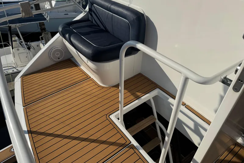 Slide: The Image of 2002 Viking 61 Enclosed Bridge yacht deck with seating and stair access. - 21