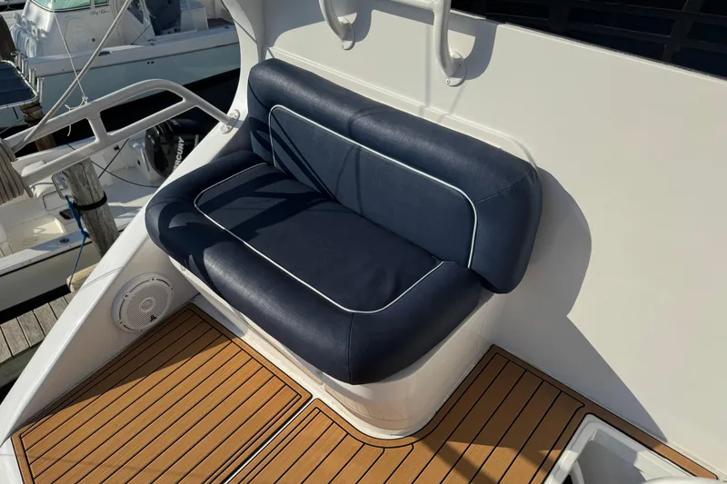 Slide: The Image of Blue cushioned seat on 2002 Viking 61 Enclosed Bridge yacht with teak flooring. - 22