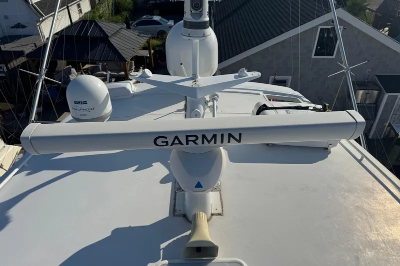 Slide: The Image of 2002 Viking 61 Enclosed Bridge with Garmin radar and KVH TracPhone on deck. - 24