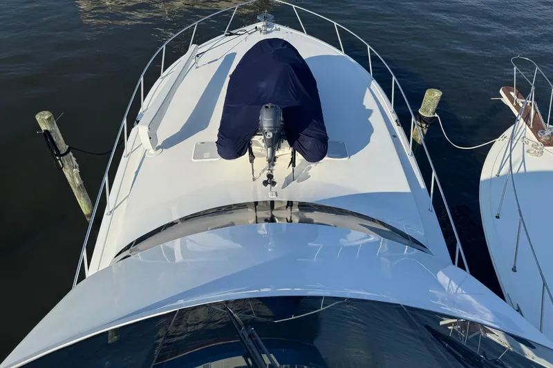Slide: The Image of 2002 Viking 61 Enclosed Bridge yacht docked, aerial view of bow and deck. - 27