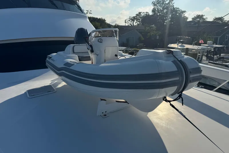 Slide: The Image of 2002 Viking 61 Enclosed Bridge yacht with inflatable dinghy on deck. - 31