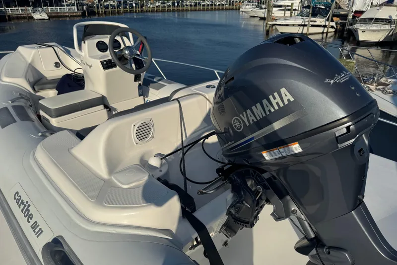 Slide: The Image of Inflatable boat with Yamaha outboard motor, docked near Viking 61 Enclosed Bridge, 2002 model. - 34