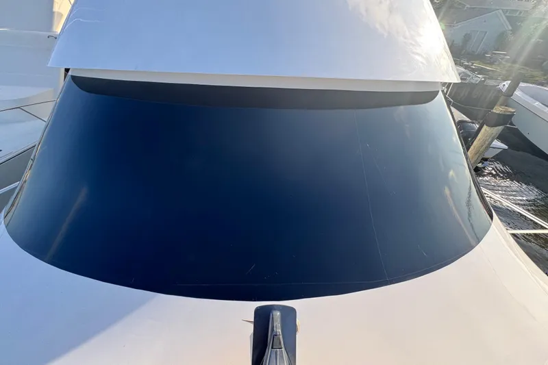 Slide: The Image of 2002 Viking 61 Enclosed Bridge yacht, close-up of sleek windshield design. - 38