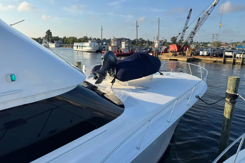 Slide: The Image of 2002 Viking 61 Enclosed Bridge yacht docked at marina with covered equipment. - 4