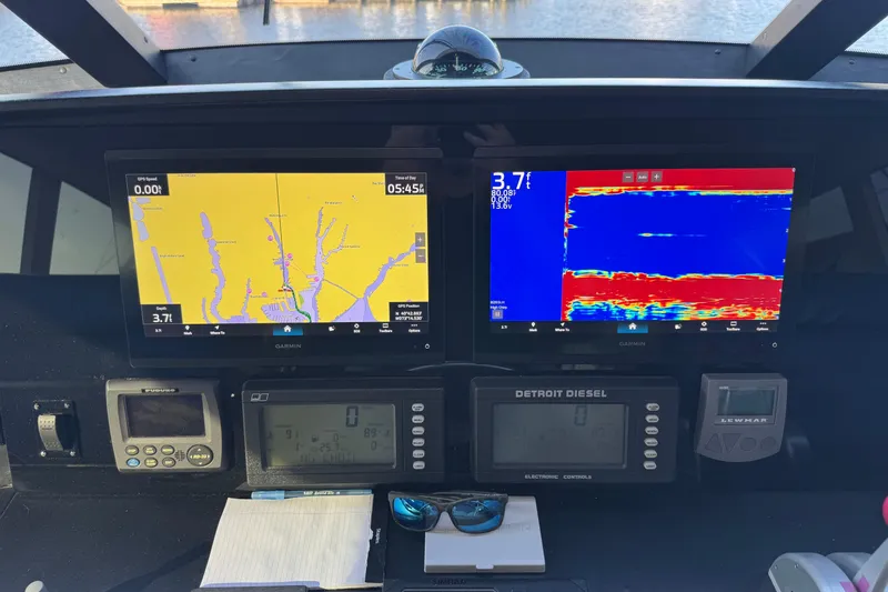Slide: The Image of Control panel of a 2002 Viking 61 Enclosed Bridge with navigation displays. - 41