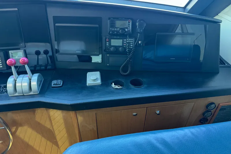 Slide: The Image of Control panel of 2002 Viking 61 Enclosed Bridge yacht with navigation equipment. - 44