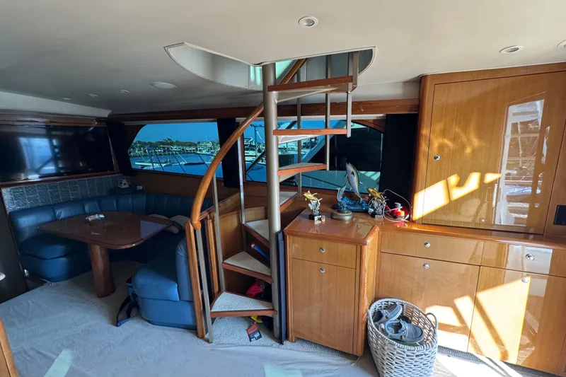 Slide: The Image of Interior of 2002 Viking 61 Enclosed Bridge yacht with spiral staircase and seating area. - 53