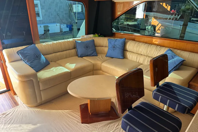 Slide: The Image of Luxurious interior of 2002 Viking 61 Enclosed Bridge yacht with plush seating and elegant decor. - 56