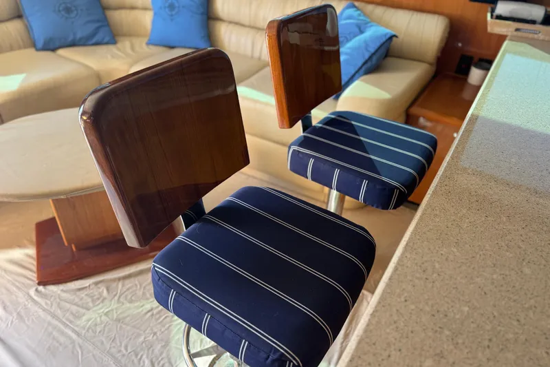 Slide: The Image of Luxurious interior of 2002 Viking 61 Enclosed Bridge with stylish bar stools and seating. - 60