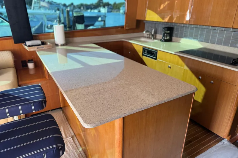 Slide: The Image of Luxurious kitchen interior of 2002 Viking 61 Enclosed Bridge yacht with modern amenities. - 61