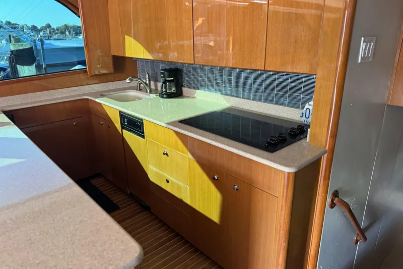 Slide: The Image of Luxurious kitchen interior of 2002 Viking 61 Enclosed Bridge yacht with modern appliances. - 62