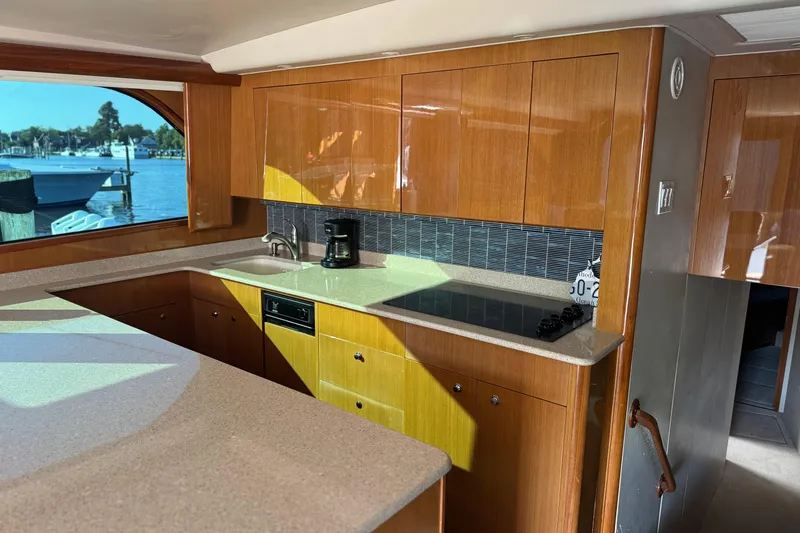 Slide: The Image of Luxurious kitchen interior of 2002 Viking 61 Enclosed Bridge yacht with modern amenities. - 63