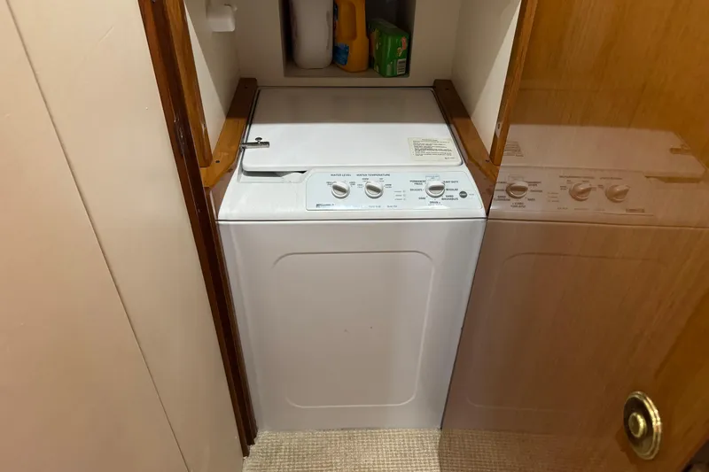 Slide: The Image of Laundry area with washing machine on 2002 Viking 61 Enclosed Bridge yacht. - 69