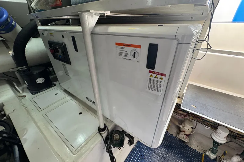 Slide: The Image of Engine room of 2002 Viking 61 Enclosed Bridge with Kohler generator. - 84