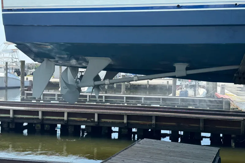 Slide: The Image of 2002 Viking 61 Enclosed Bridge yacht propellers and hull at dockside. - 86