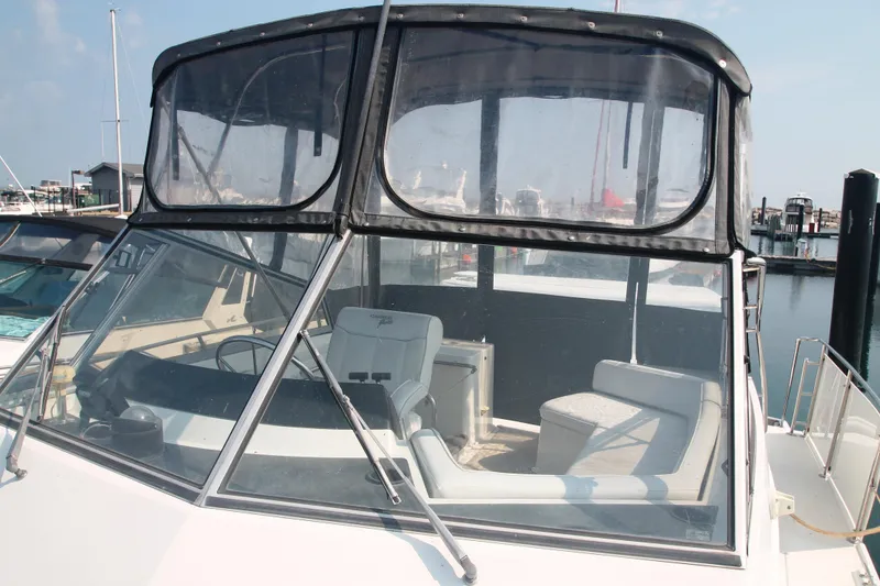 Slide: The Image of 1995 Carver 330 Mariner boat with enclosed cockpit at marina. - 10