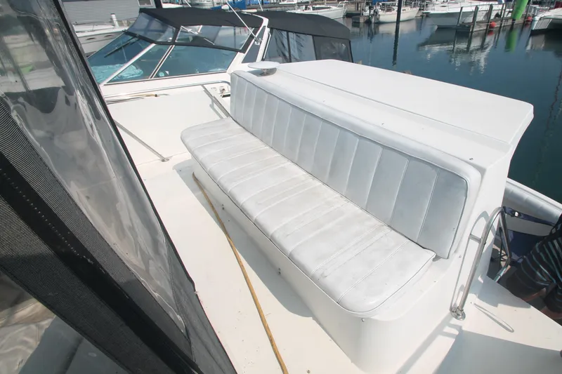 Slide: The Image of 1995 Carver 330 Mariner boat with white seating on deck, docked at marina. - 14