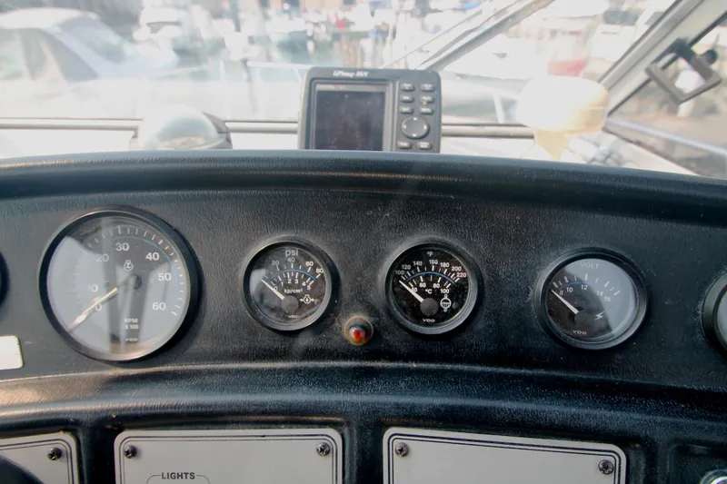 Slide: The Image of Dashboard of a 1995 Carver 330 Mariner boat with gauges and navigation equipment. - 20