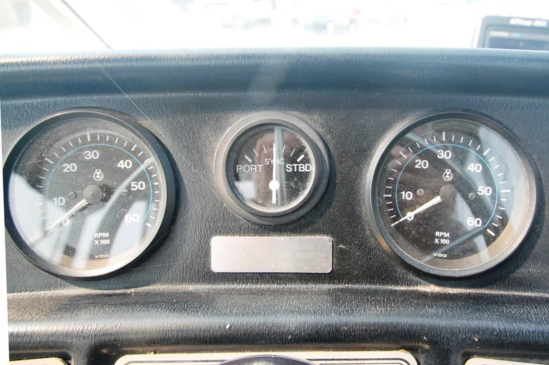 Slide: The Image of 1995 Carver 330 Mariner dashboard with RPM gauges and port-starboard indicator. - 21
