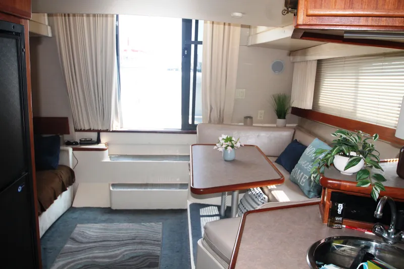 Slide: The Image of Interior of 1995 Carver 330 Mariner yacht with cozy seating and dining area. - 29