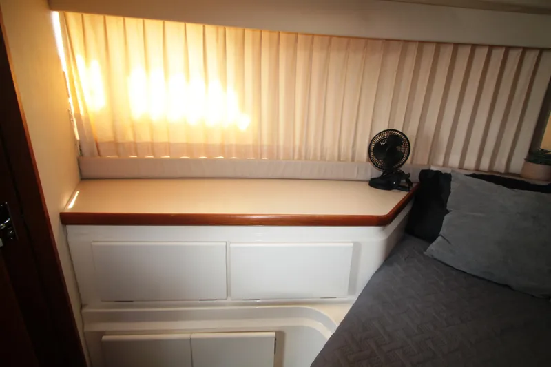 Slide: The Image of Interior of 1995 Carver 330 Mariner with bed, fan, and window blinds. - 41