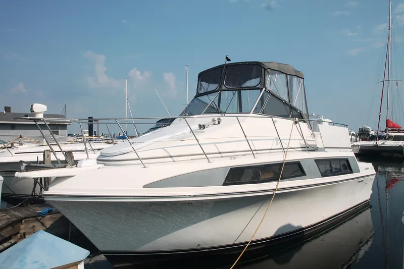 Slide: The Image of 1995 Carver 330 Mariner yacht docked at marina under clear blue sky. - 1
