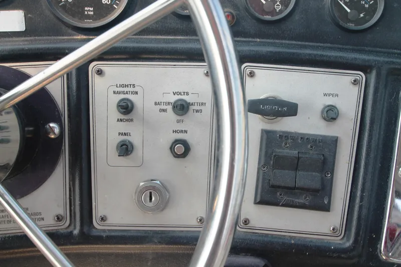 Slide: The Image of Control panel of a 1995 Carver 330 Mariner boat with various switches and gauges. - 18