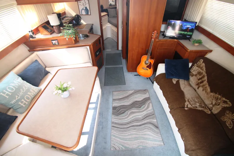 Slide: The Image of Interior of a 1995 Carver 330 Mariner yacht with cozy seating and decor. - 28