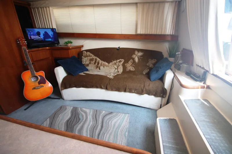 Slide: The Image of Cozy interior of 1995 Carver 330 Mariner with guitar, sofa, and TV. - 32