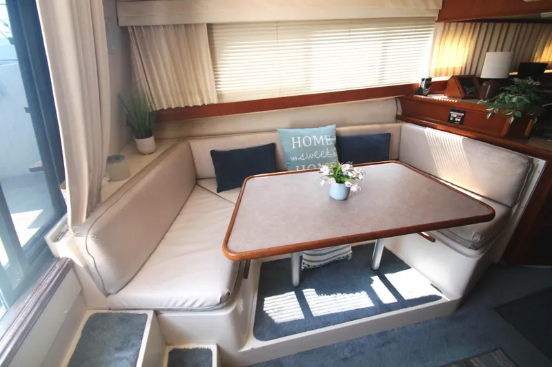 Slide: The Image of Cozy interior of 1995 Carver 330 Mariner with dining area and decorative pillows. - 33