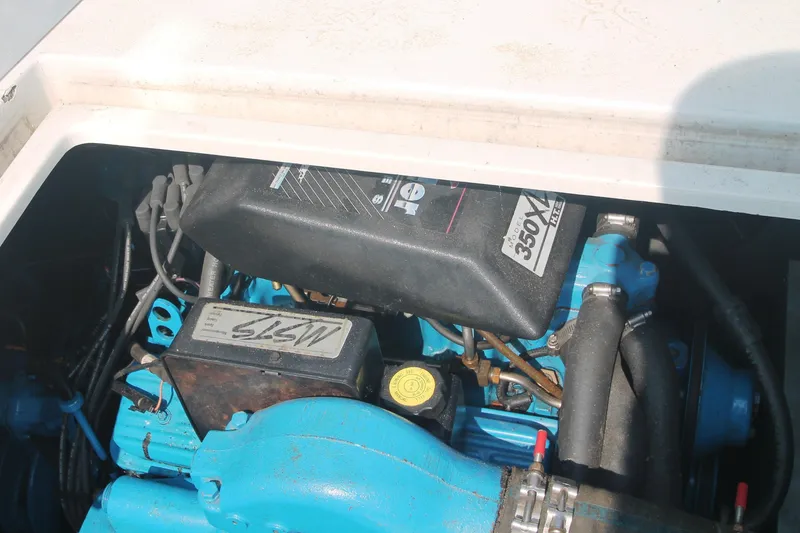 Slide: The Image of Engine compartment of a 1995 Carver 330 Mariner boat, featuring a 350 XL engine. - 48