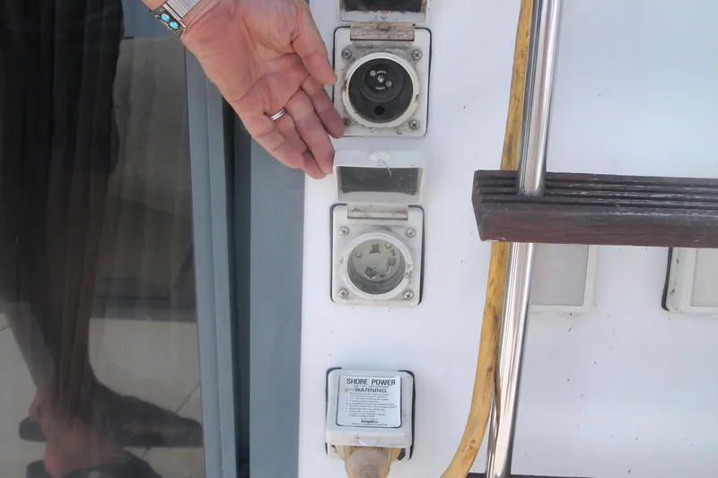 Slide: The Image of Hand near shore power connections on 1995 Carver 330 Mariner boat. - 52