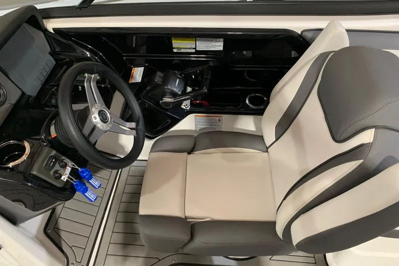 Slide: The Image of 2017 Yamaha Boats 212 Limited cockpit with steering wheel and captain's seat. - 11