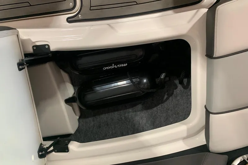 Slide: The Image of Storage compartment in a 2017 Yamaha Boats 212 Limited, featuring black fenders. - 14
