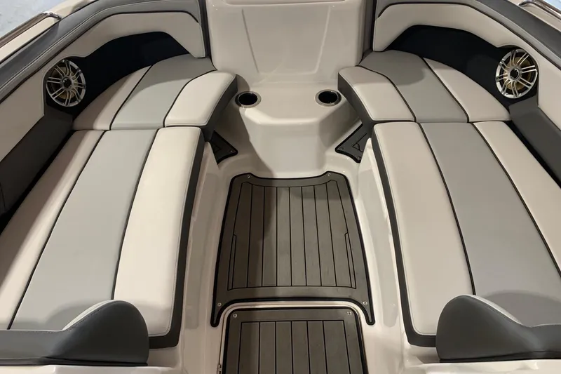 Slide: The Image of 2017 Yamaha Boats 212 Limited interior with gray seating and speakers. - 18