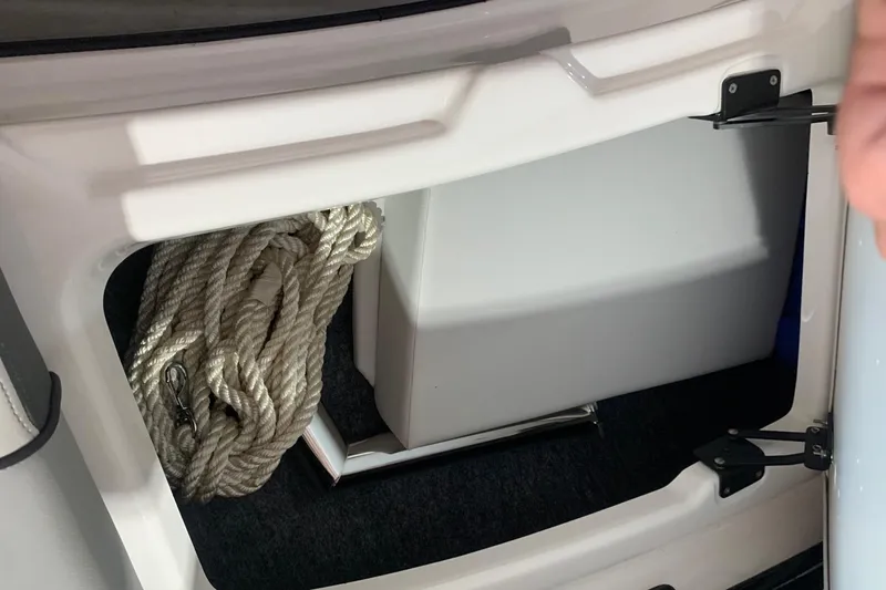 Slide: The Image of Storage compartment in a 2017 Yamaha Boats 212 Limited with coiled rope inside. - 22