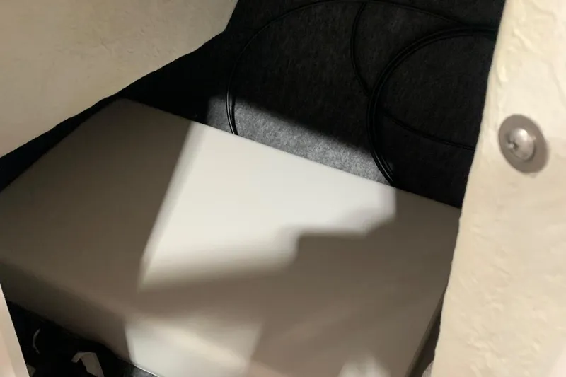 Slide: The Image of 2017 Yamaha Boats 212 Limited interior storage compartment with cushioned seating. - 25