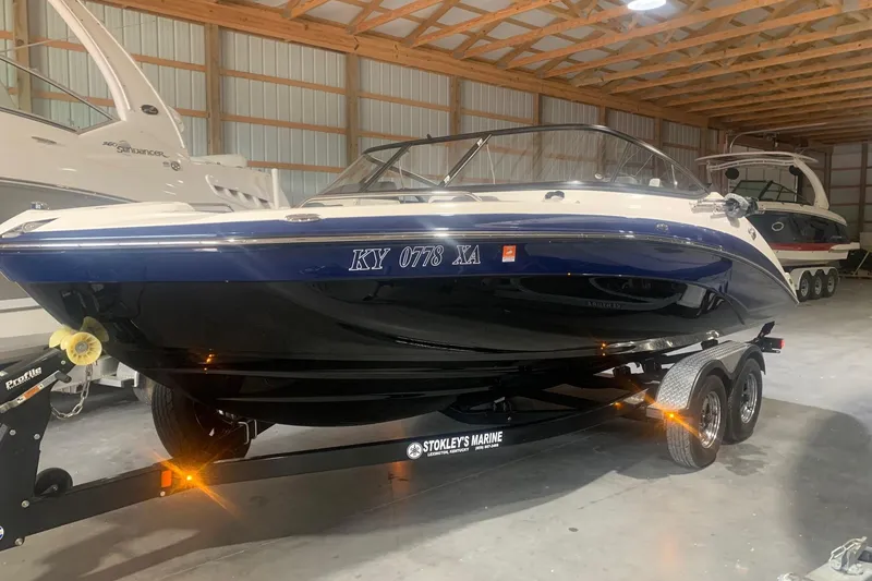 Slide: The Image of 2017 Yamaha Boats 212 Limited on trailer in indoor storage facility. - 4