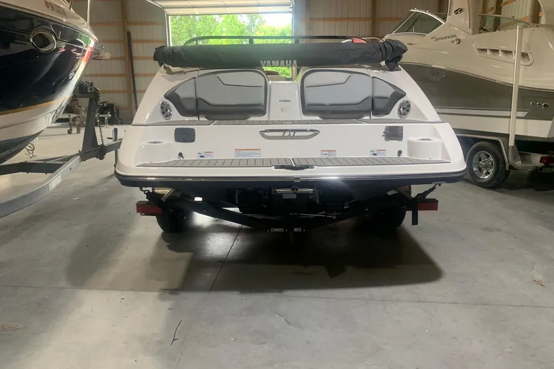 Slide: The Image of 2017 Yamaha Boats 212 Limited in a storage facility, rear view. - 5