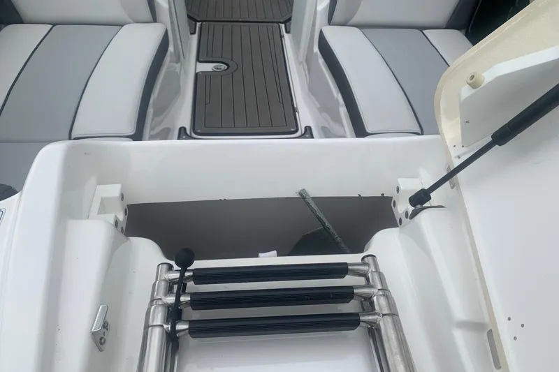 Slide: The Image of 2017 Yamaha Boats 212 Limited interior with seating and storage compartment. - 7