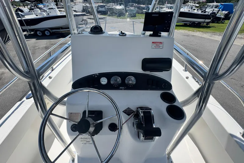 Slide: The Image of 2005 Boston Whaler 190 Nantucket boat console with steering wheel and gauges. - 13