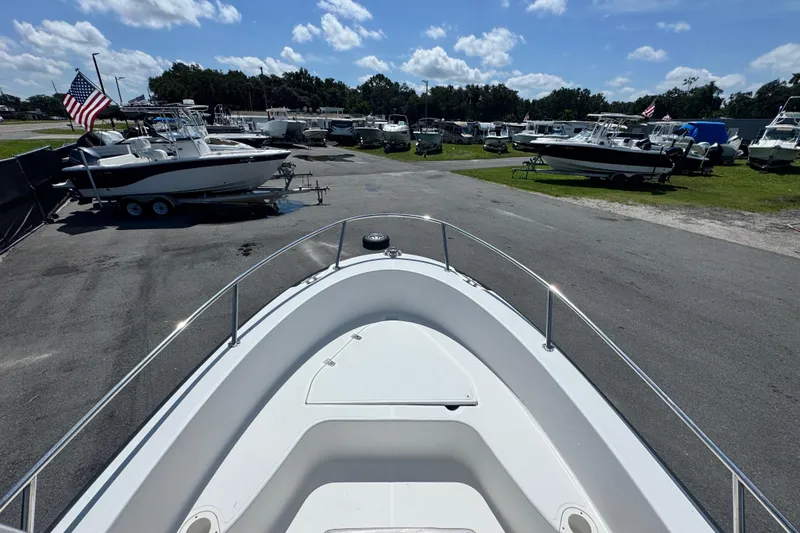 Slide: The Image of 2005 Boston Whaler 190 Nantucket boat in a marina with other vessels. - 19
